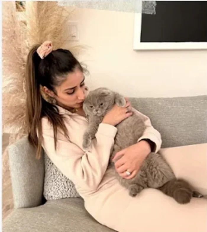 Zoha cuddling her Scottish Fold cat, Thor
