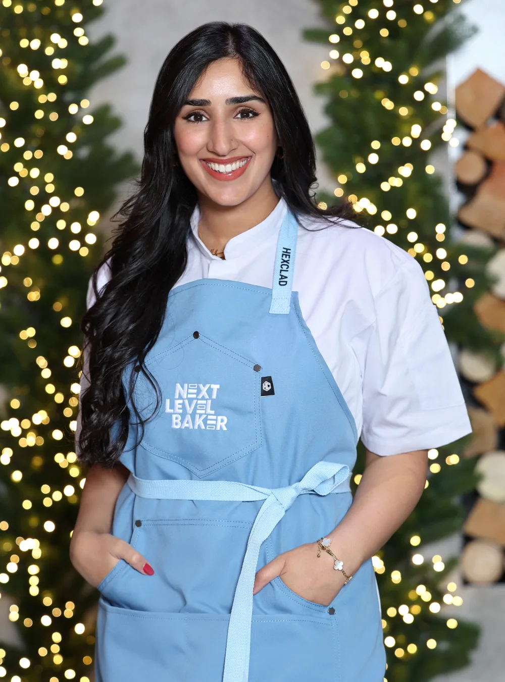 Zoha wearing her Next Level Baker apron on the holiday set