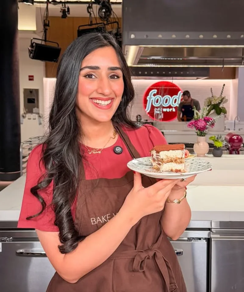 Zoha Malik holding a dessert at the Food Network Hot List