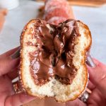Donut cut in half revealing nutella filling inside