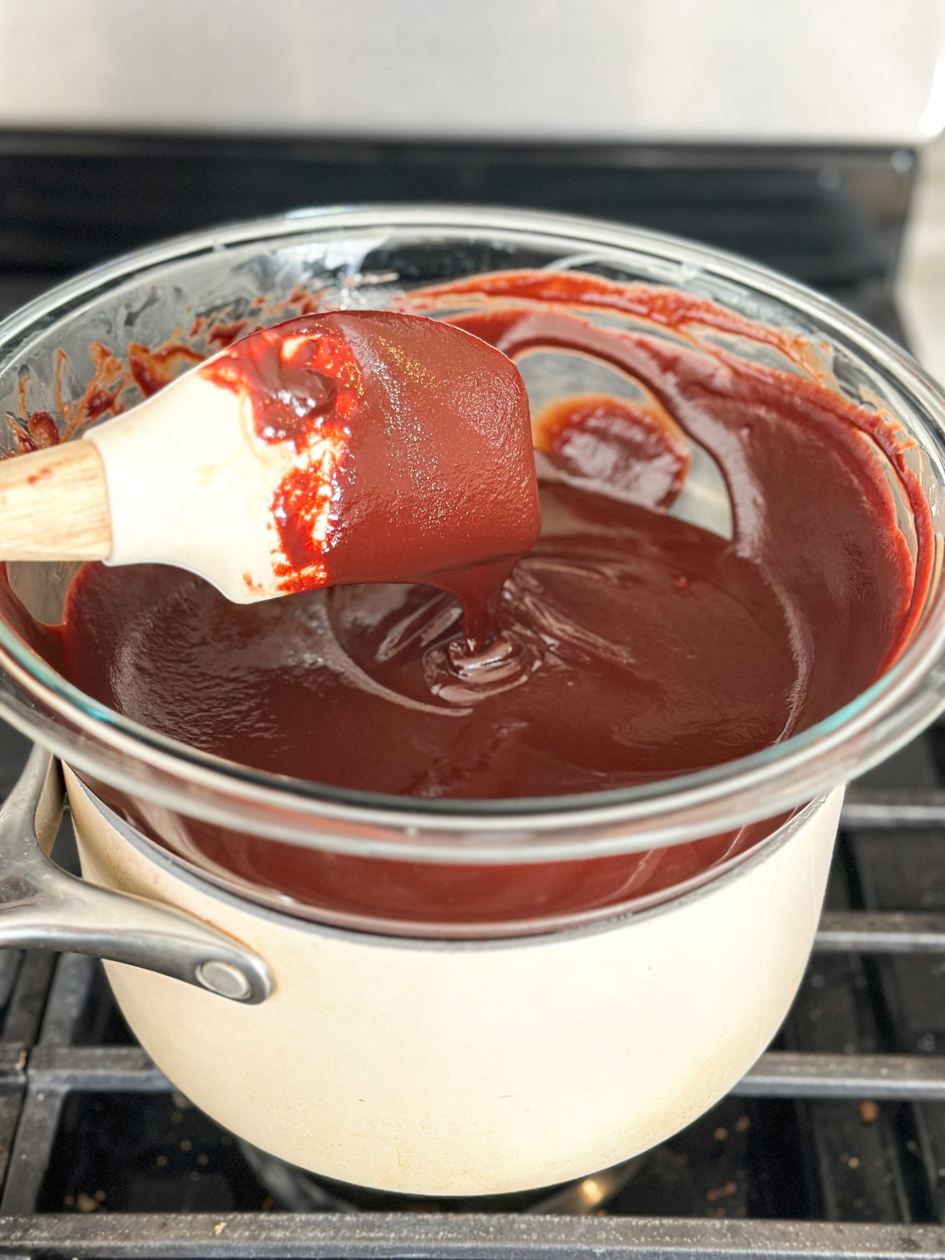 silky smooth chocolate ganache being made over a double boiler