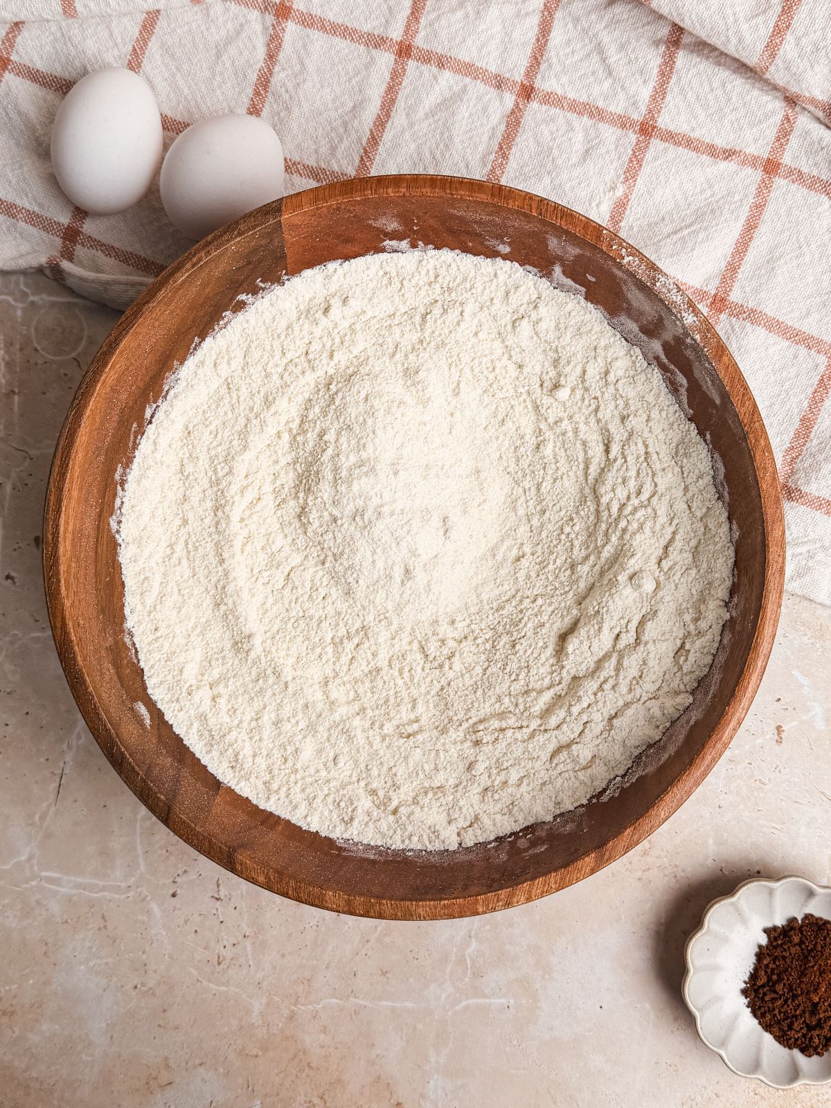 wooden bowl with dry ingredients mixed inside
