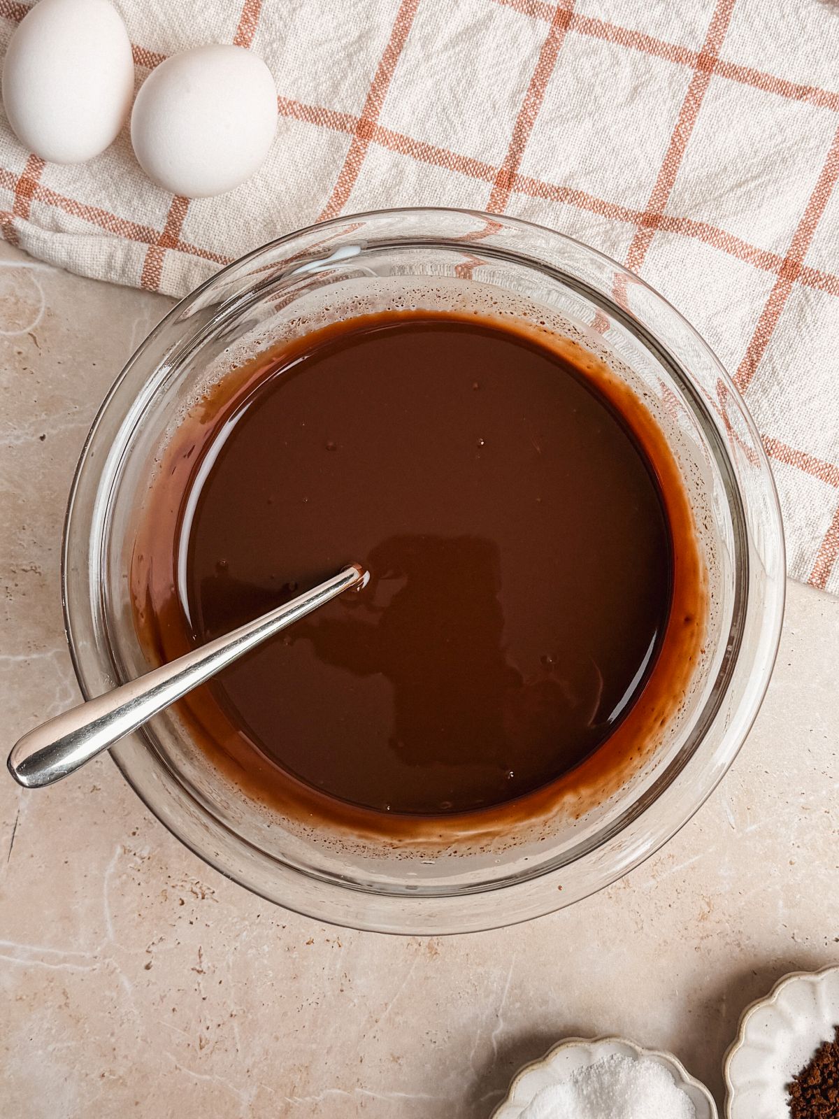 ganache in a glass bowl with a spoon resting