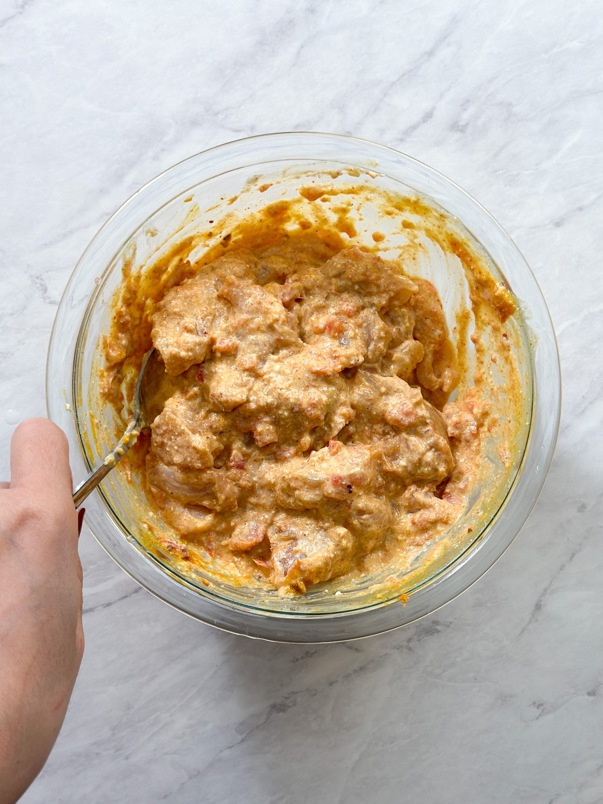 mixing chicken marinade in a glass bowl