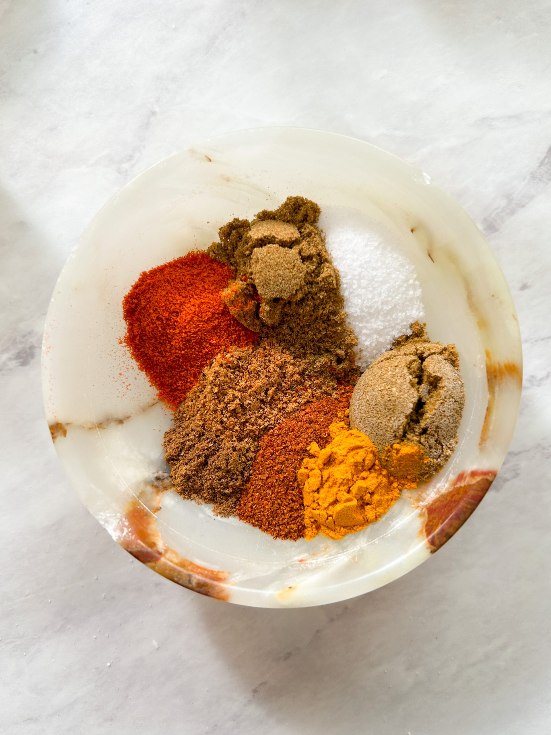 a pinch bowl with different colorful spices