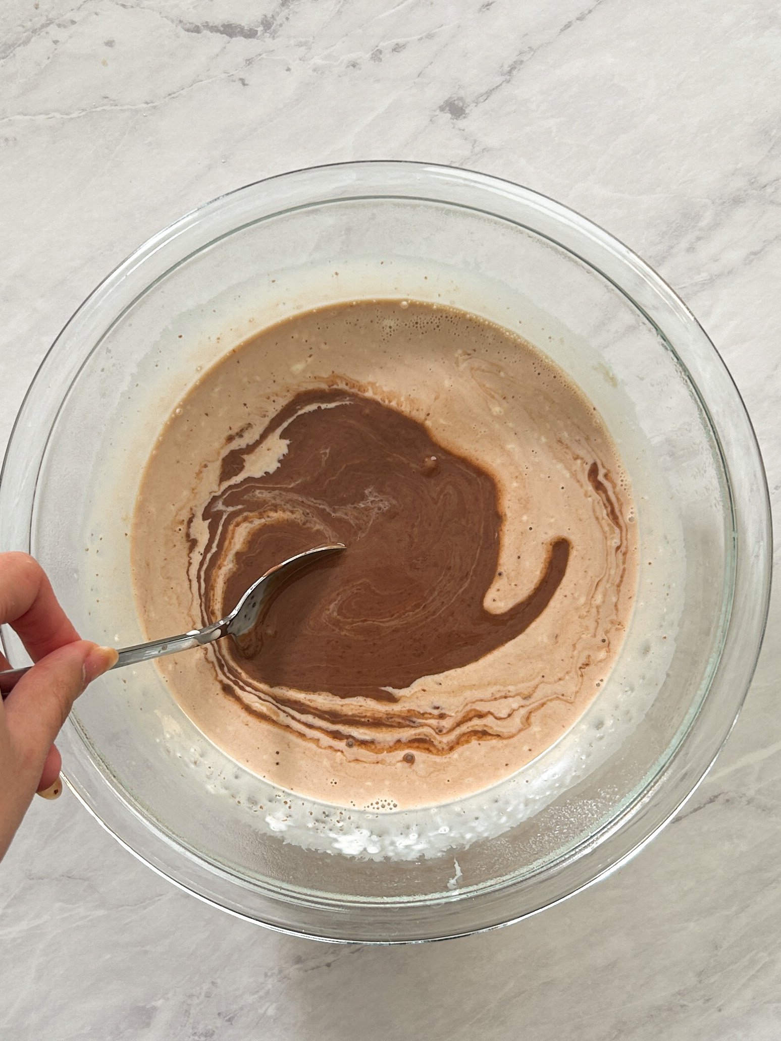 process of mixing cream and chocolate to make ganache