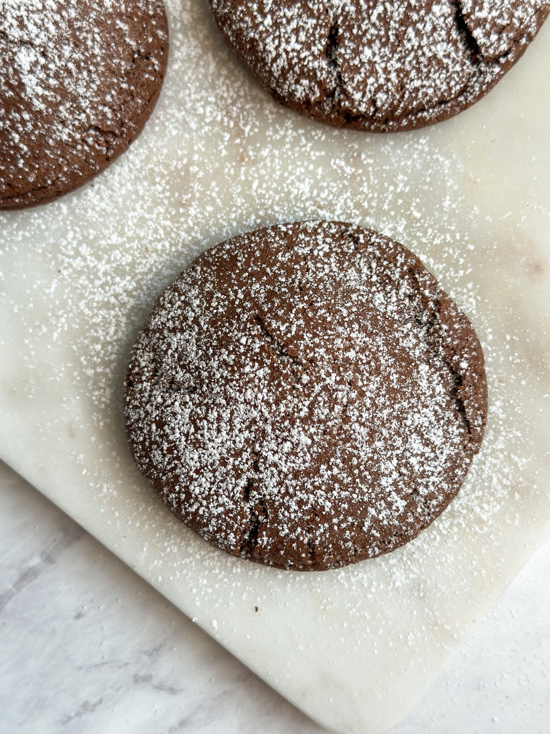 close up of chocolate lava cookie with icing sugar on top
