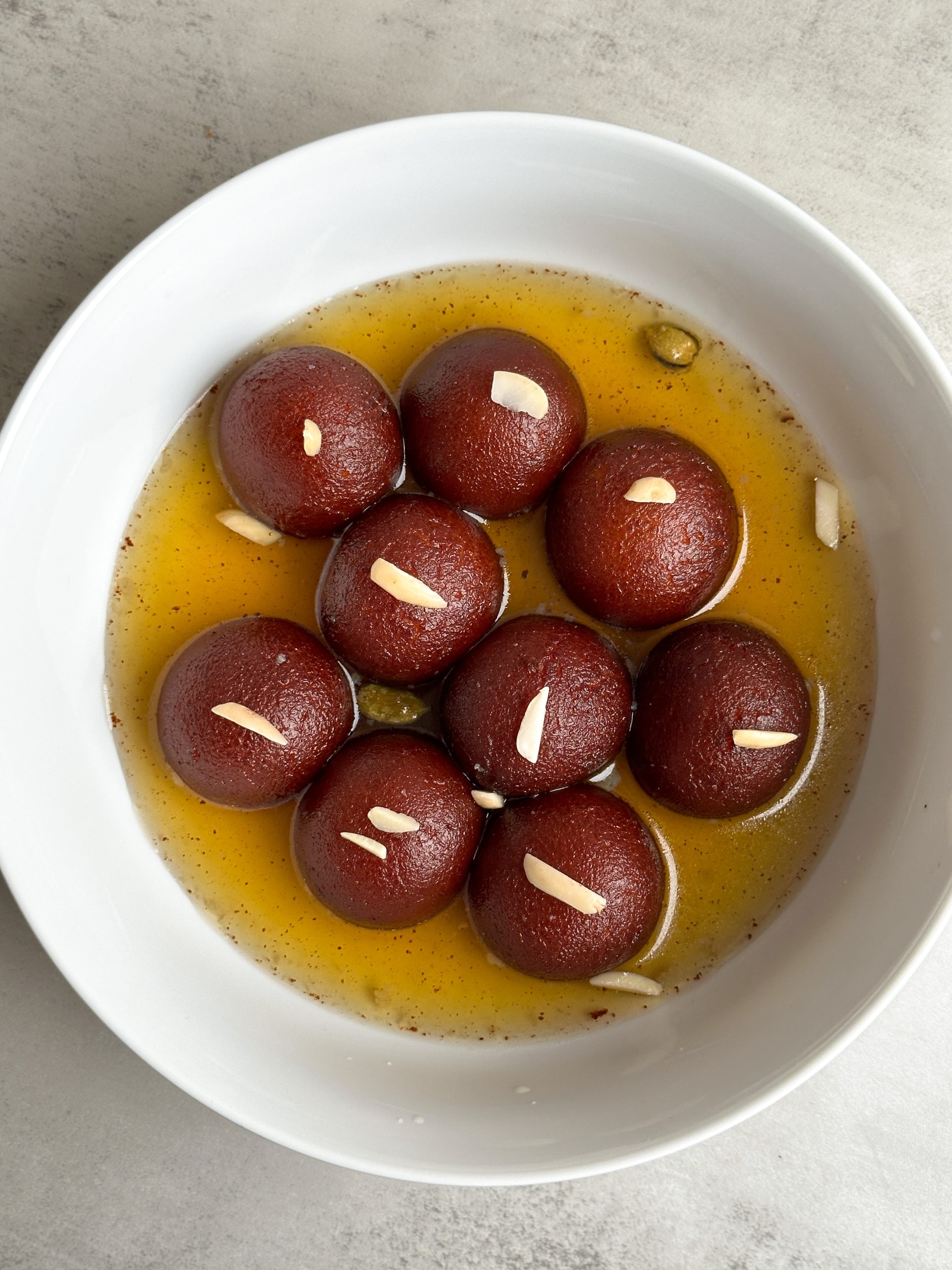 Moist brown gulab jamuns in a bowl