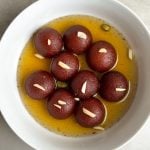 Moist brown gulab jamuns in a bowl