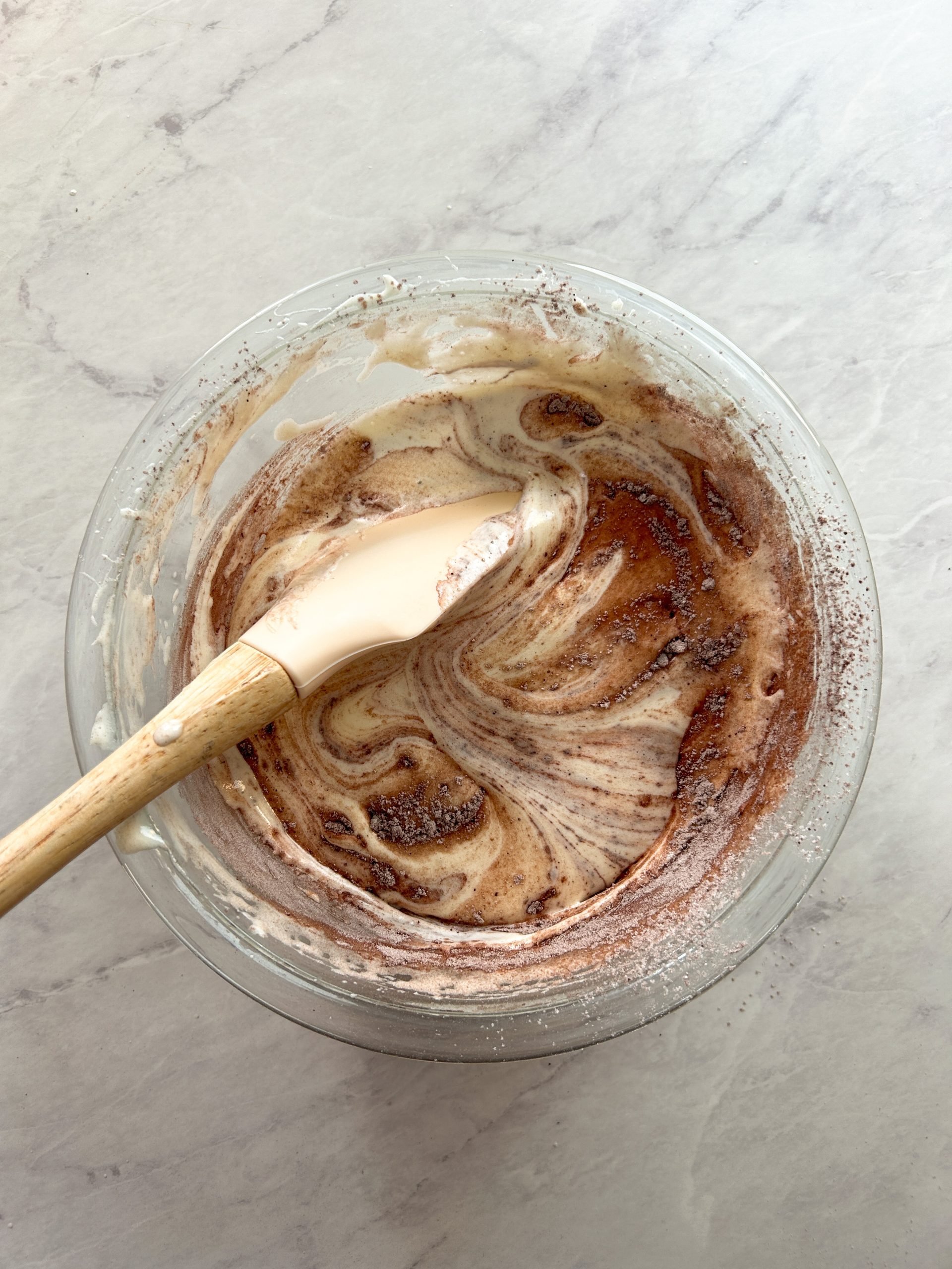 process of folding dry ingredients into chocolate cake batter