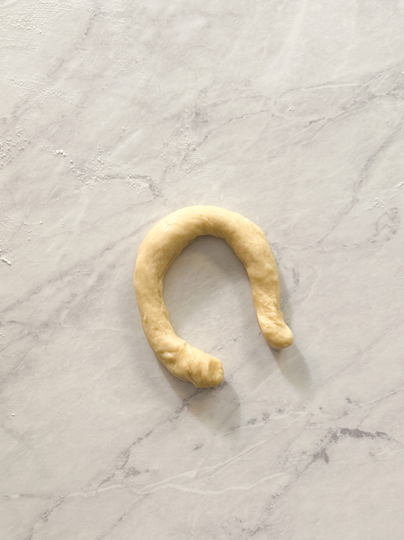 strip of dough shaped into a U