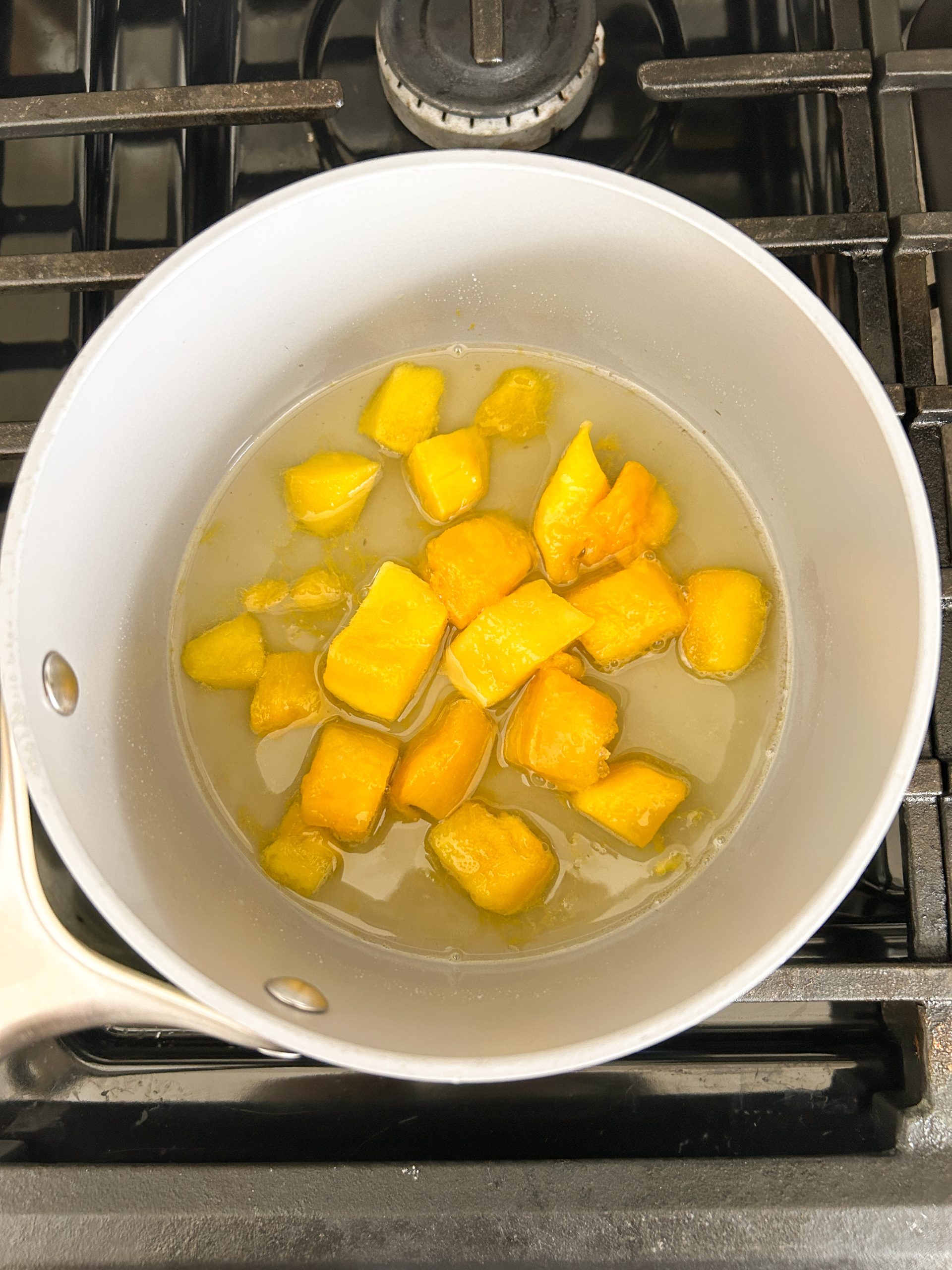 mango cubes in simple syrup in a saucepan