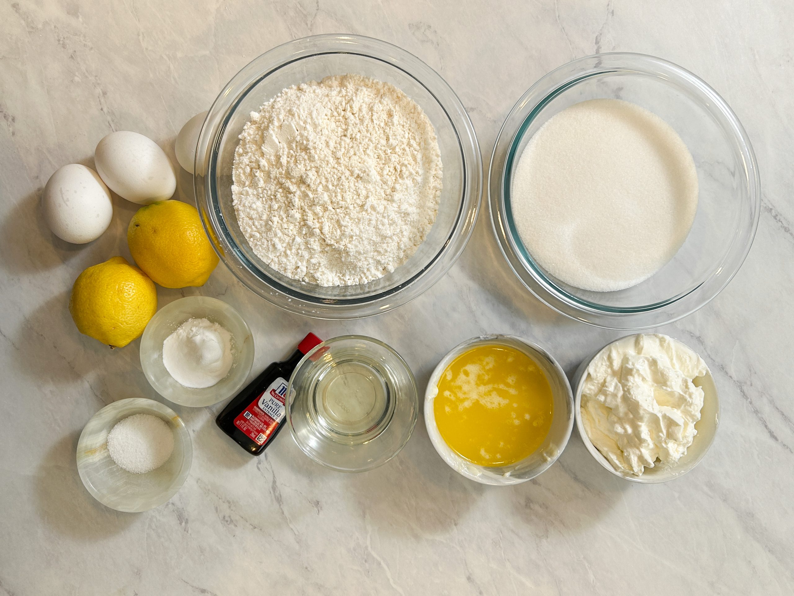 lemon cake ingredients: lemons, eggs, flour, sugar, oil, butter, salt, baking powder, soda and vanilla