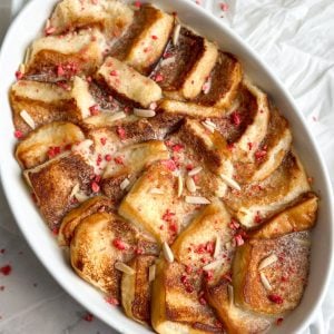 a white serving dish with shahi tukray inside - pieces of golden bread soaked in sweet milk