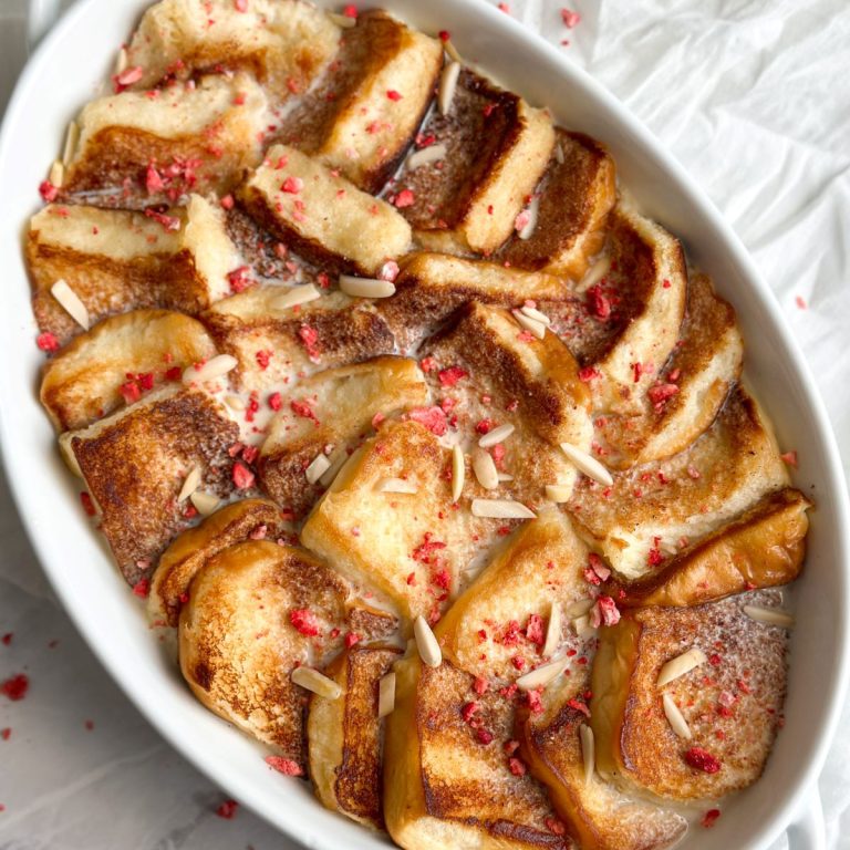 a white serving dish with shahi tukray inside - pieces of golden bread soaked in sweet milk