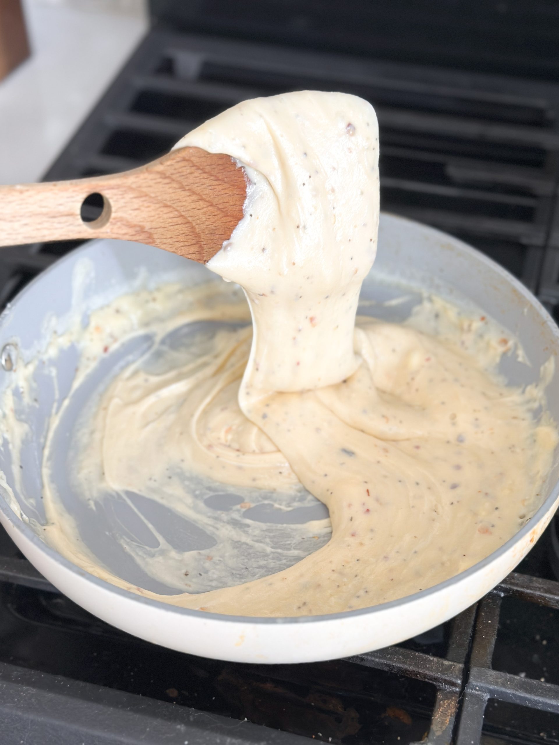 creamy and stretchy cheese sauce in a saucepan