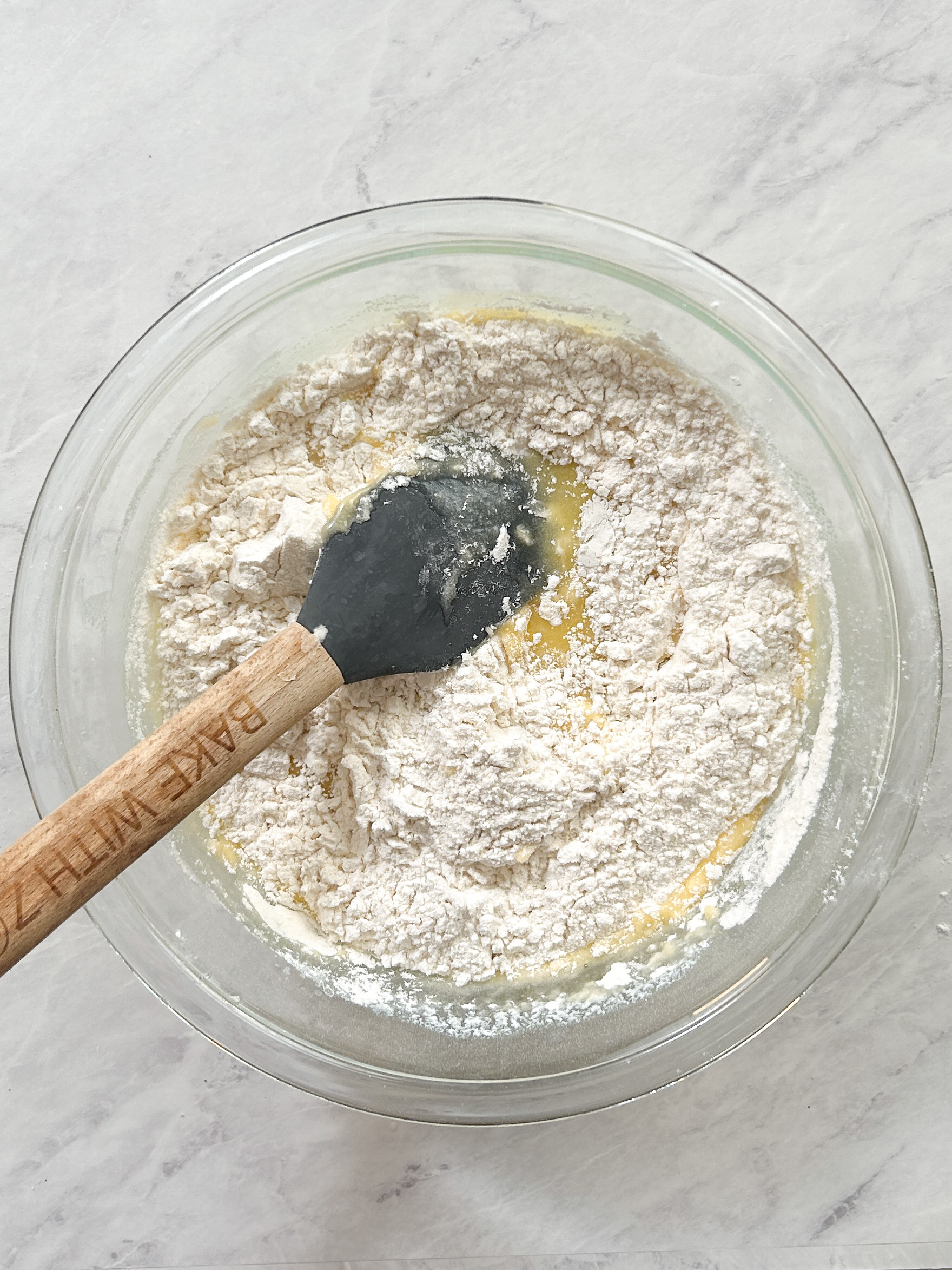 rubber spatula folding dry ingredients into cake batter