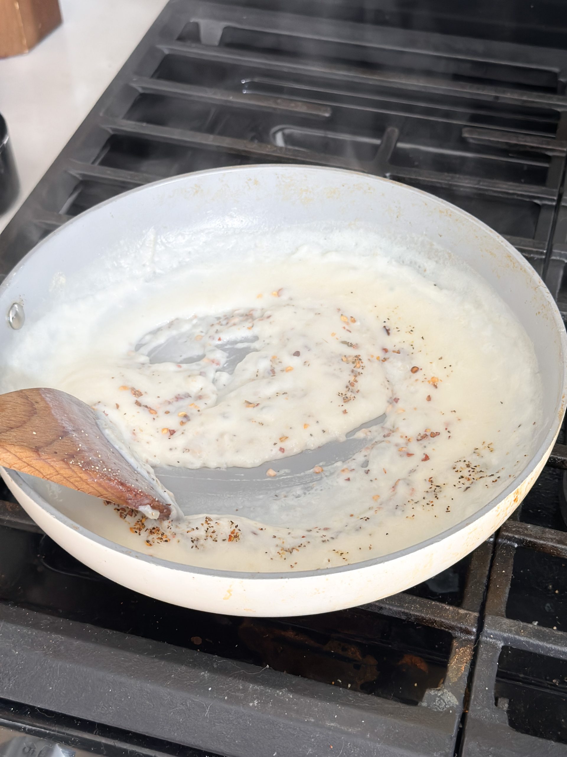 white sauce in a saucepan on the stove