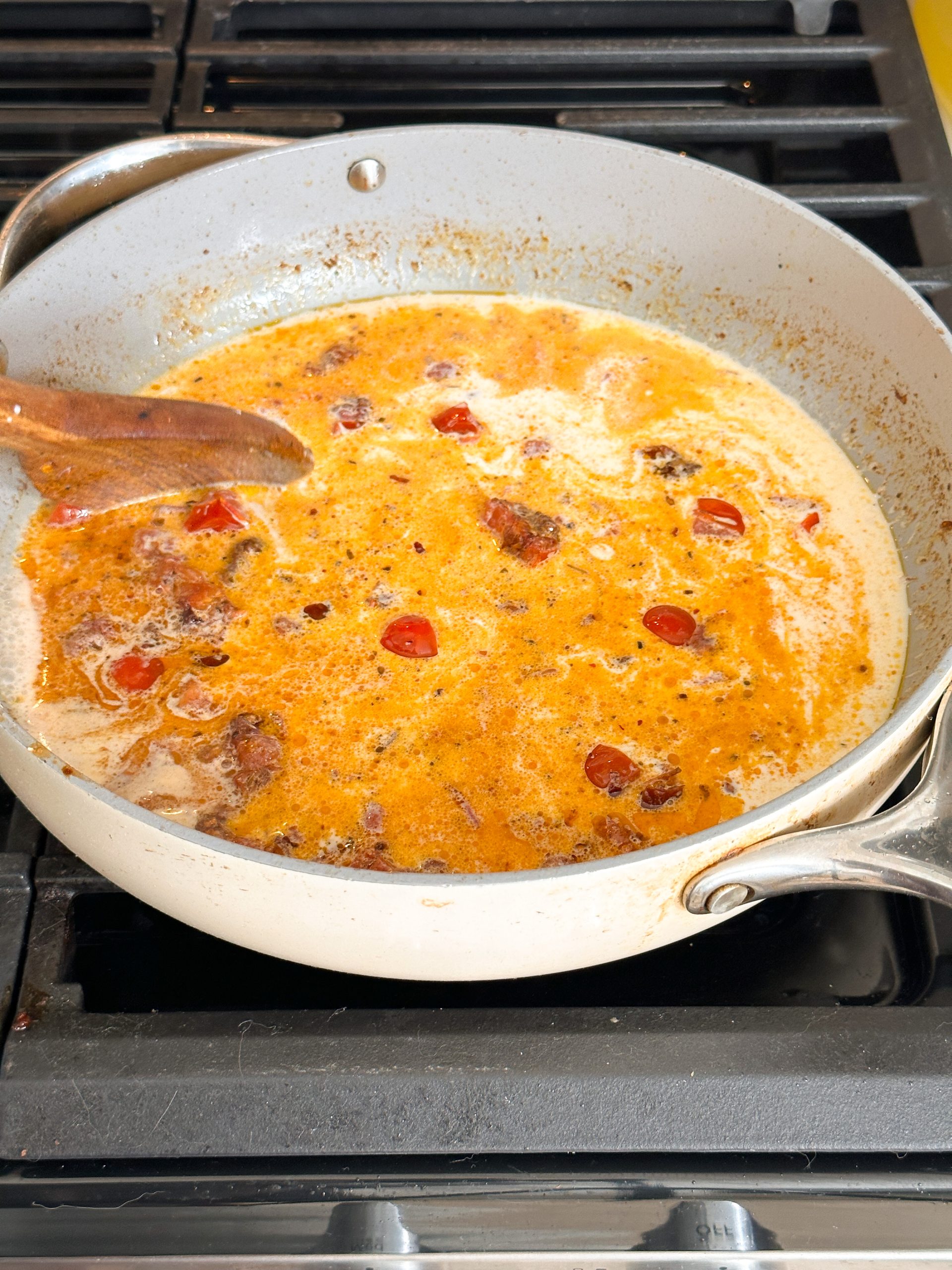pasta sauce being made with milk and cream