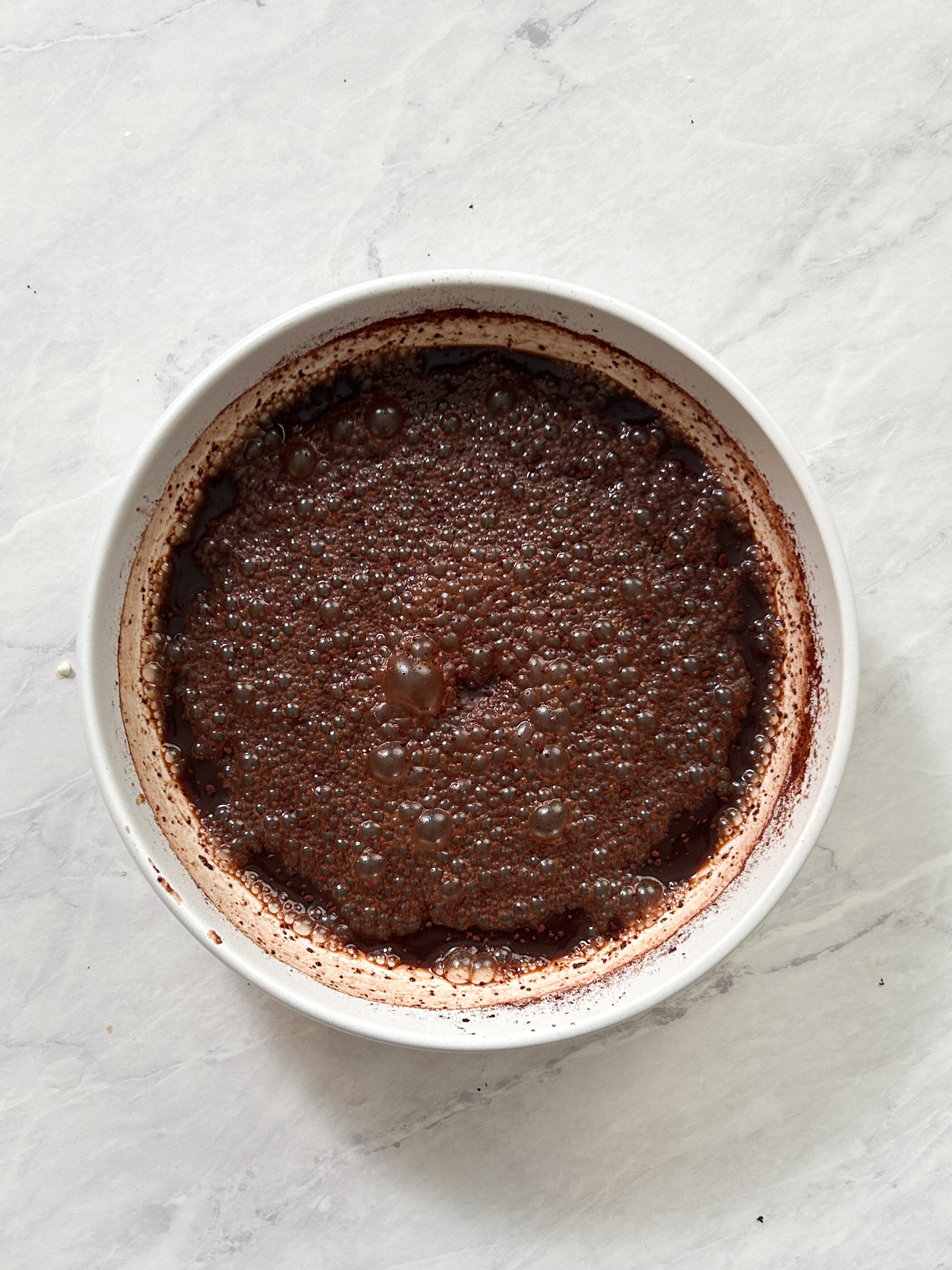 cocoa powder mixed with espresso in a large deep plate