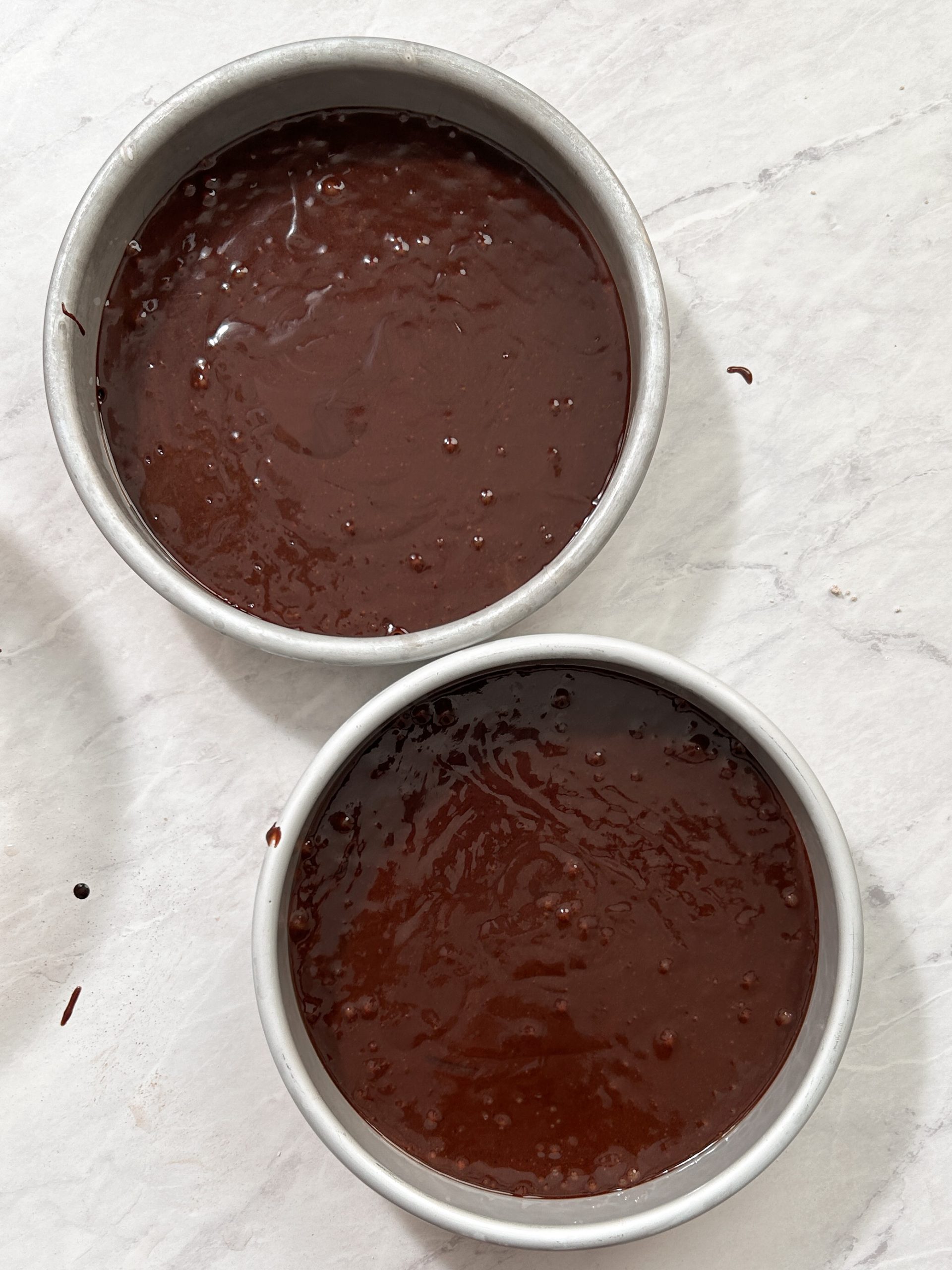 chocolate cake batter in 2 8" round pans