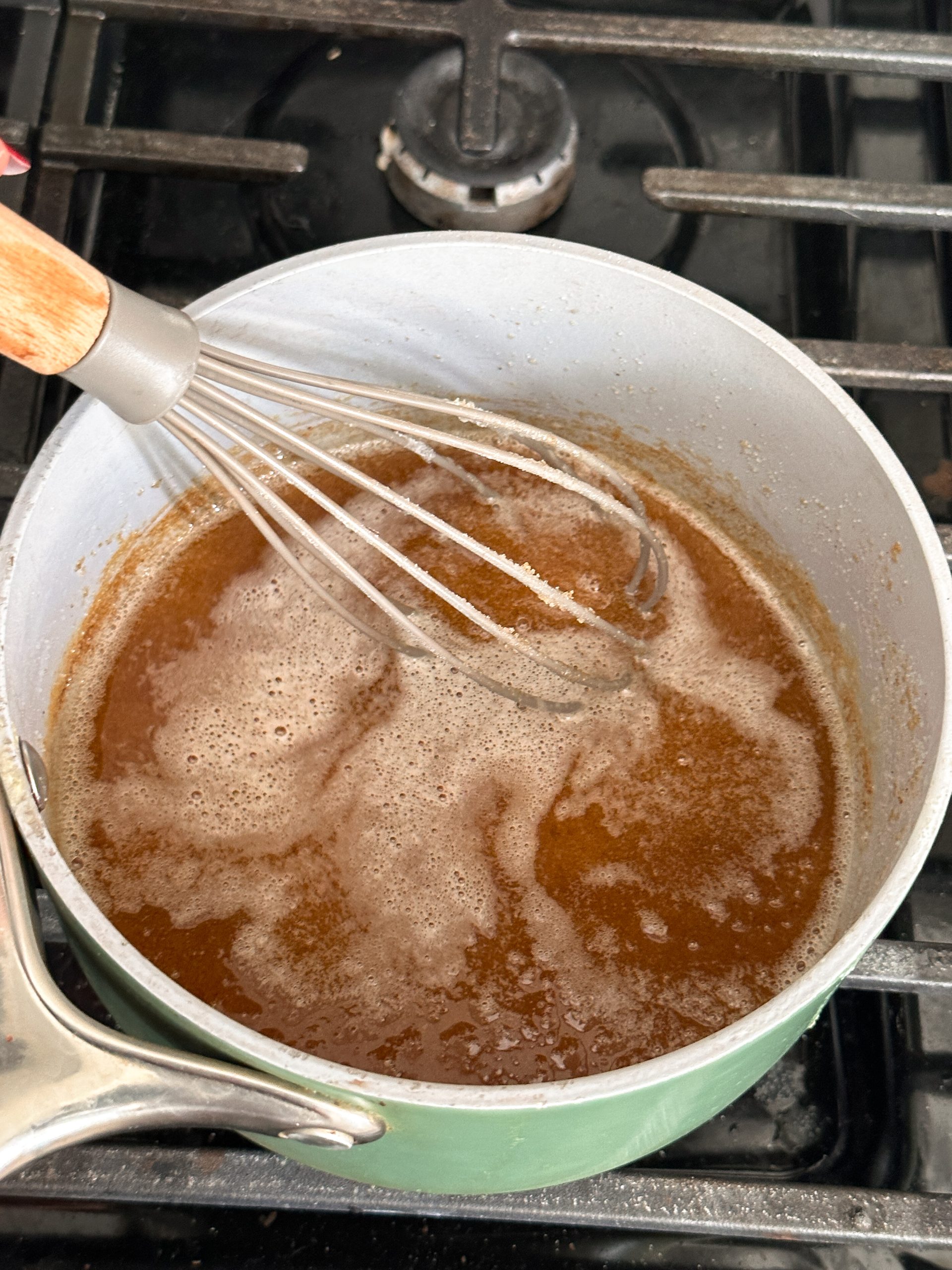 brown sugar and sugar added to browned butter in a saucepan with a whisk