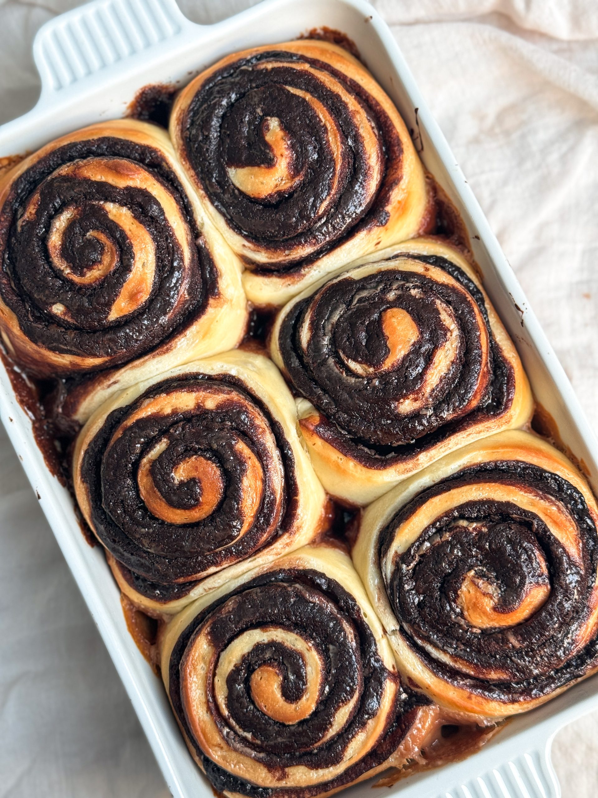 6 baked chocolate espresso rolls showing light golden bread with swirls of chocolate inside