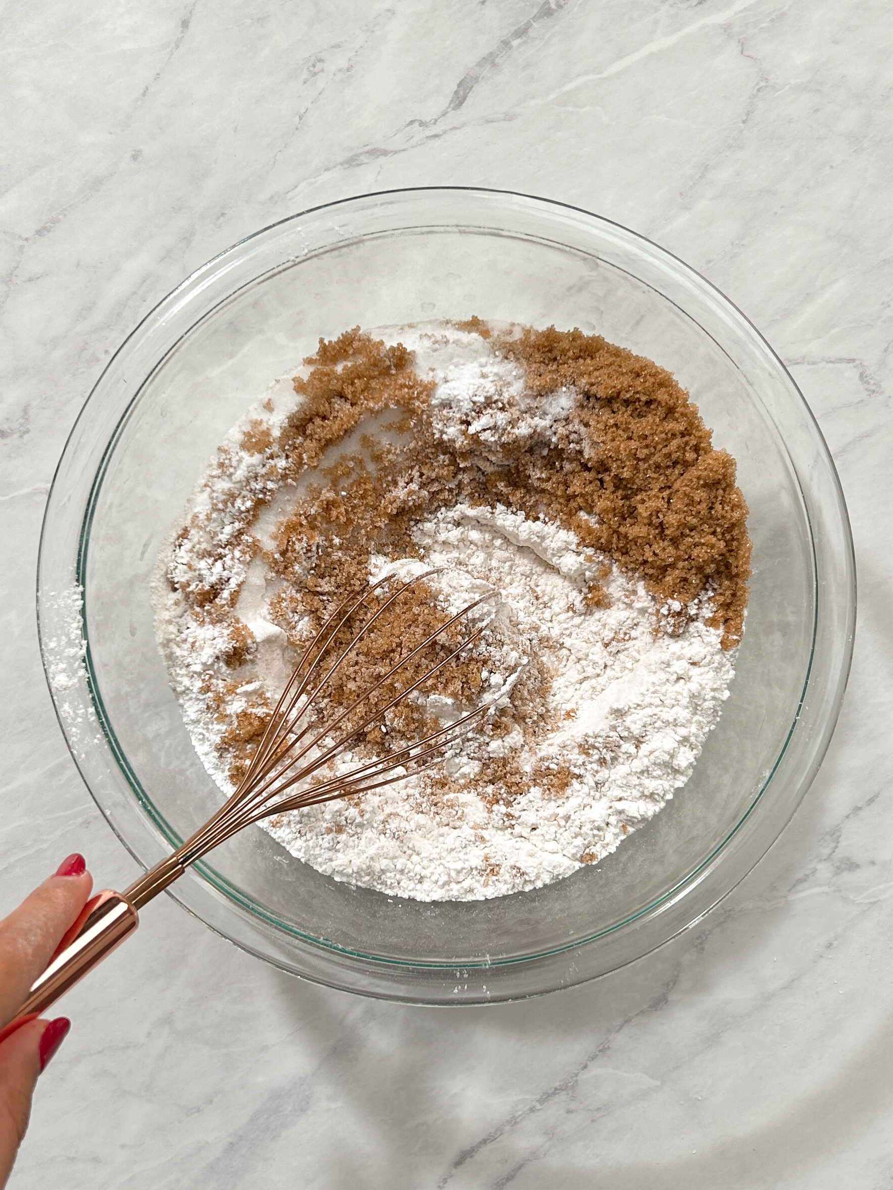 dry ingredients in a glass bowl with a whisk