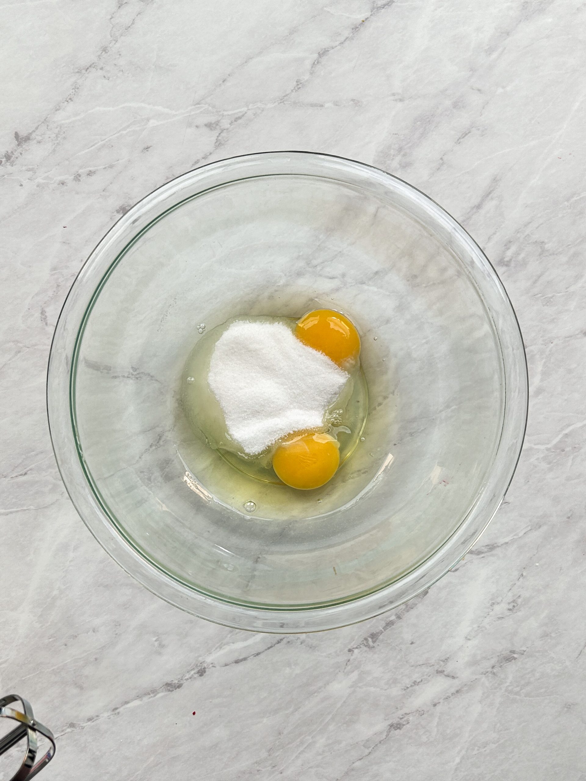 eggs and sugar in a glass bowl