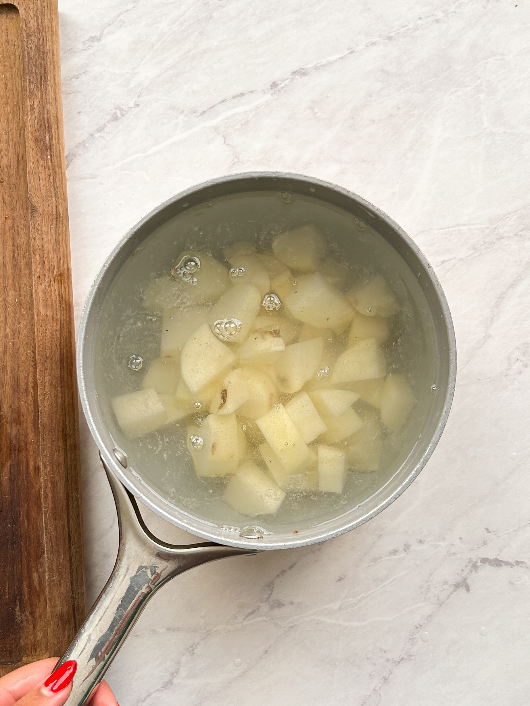 cubed potatoes in water in a saucepan