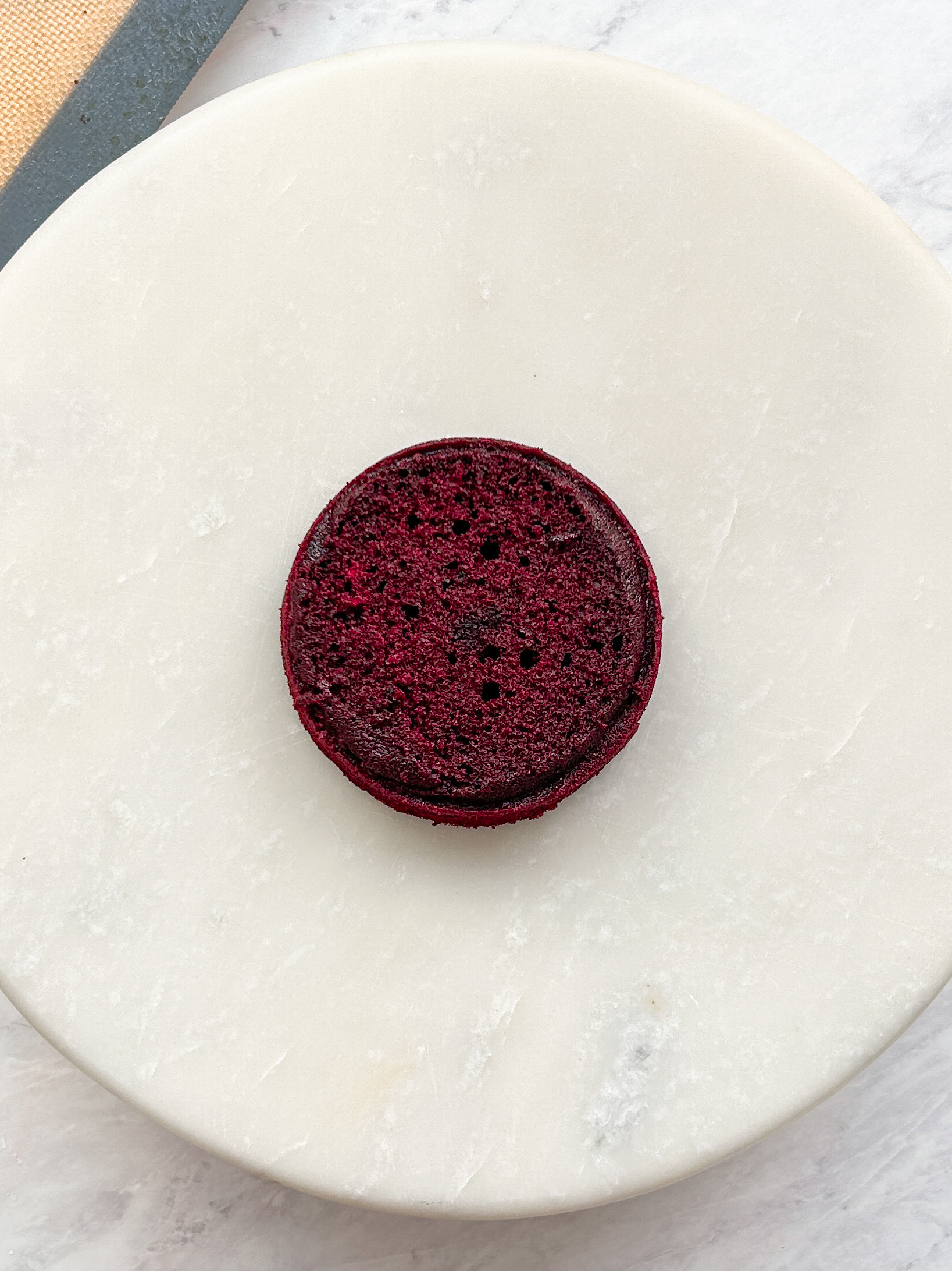 small red velvet cake on a marble serving board