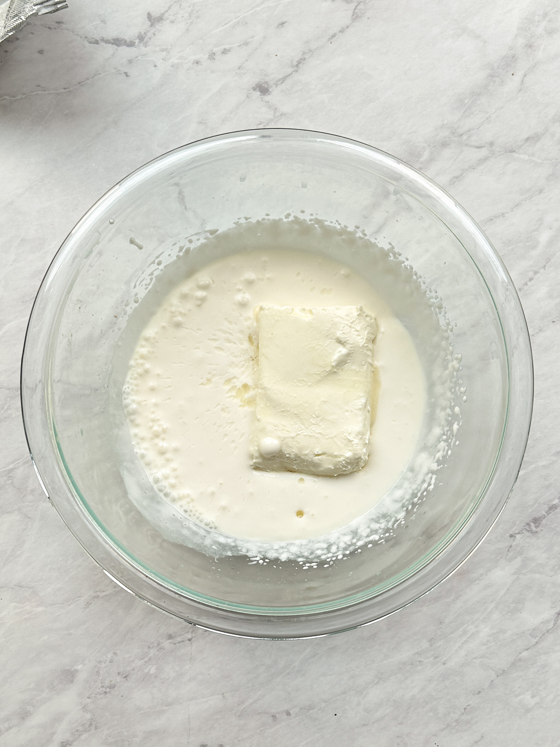 cream cheese and cream in a glass bowl