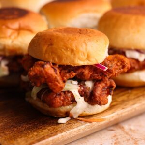 a nashville hot chicken slider with 2 fried chicken tenders and coleslaw inside