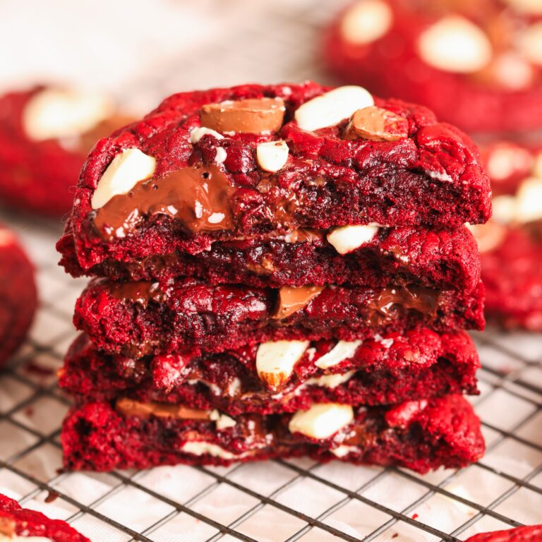 a stack of halved red velvet chocolate chip cookies with chewy gooey interiors with lots of chocolate
