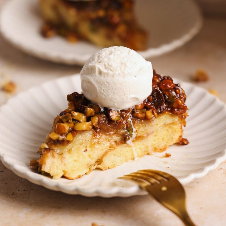 slice of baklava bread pudding on a small plate with a scoop of ice cream on top