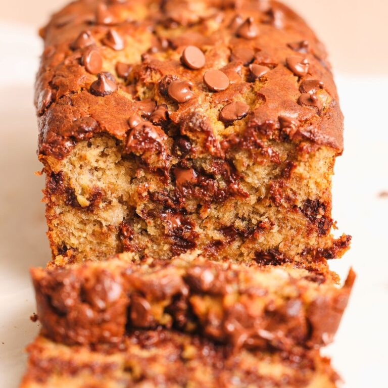 loaf of banana bread with some slices cut laying next to it