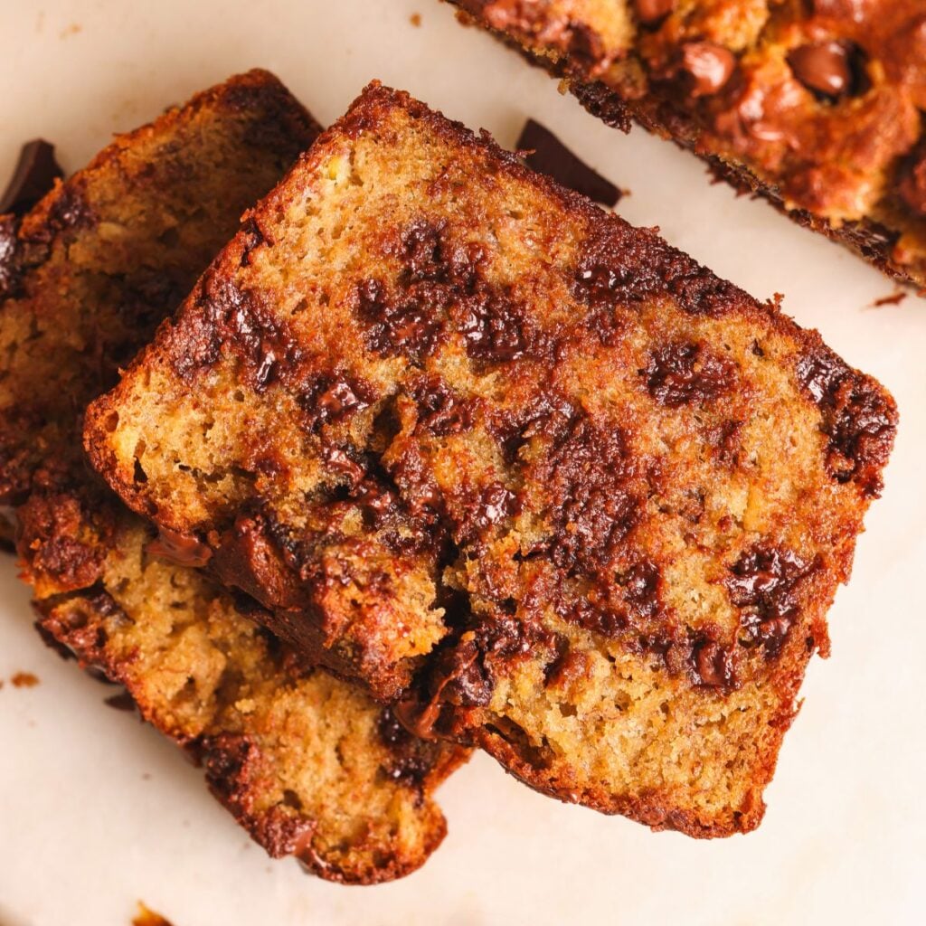 close up of a slice of banana bread. the bread looks soft and moist with lots of chocolate chips