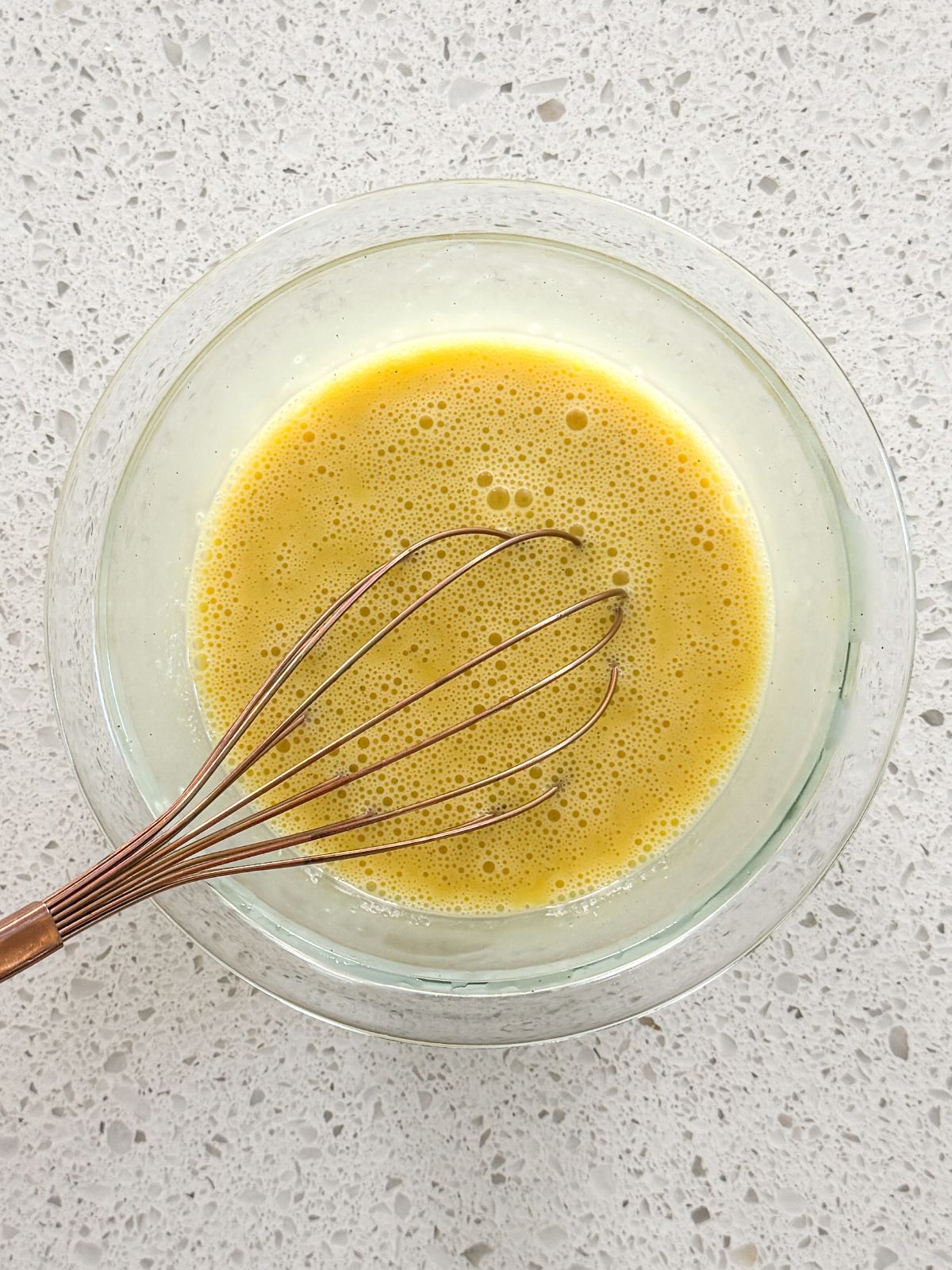 eggs whisked with buttermilk and vanilla in a small glass bowl