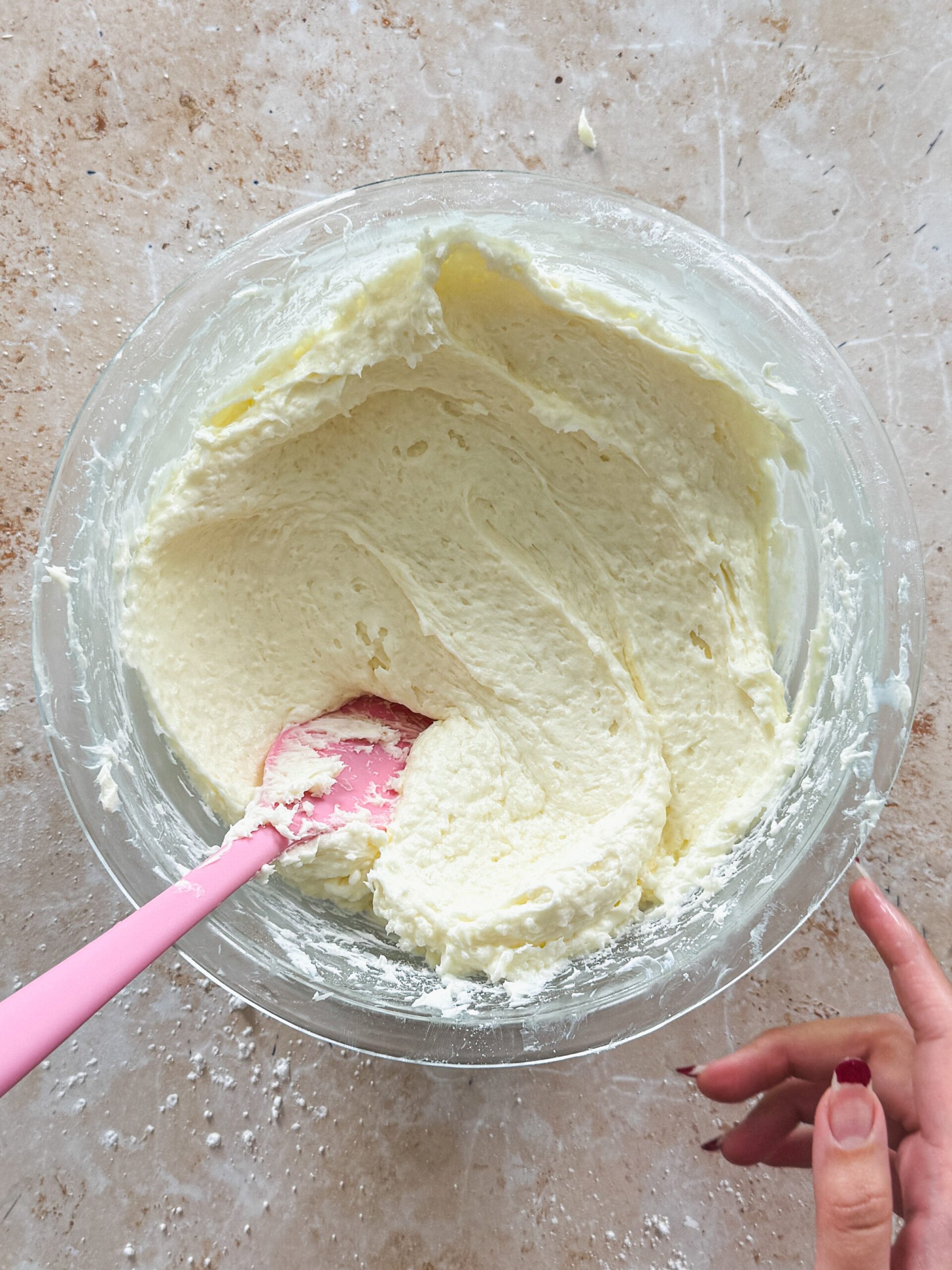creamy coconut cream cheese frosting in a glass bowl