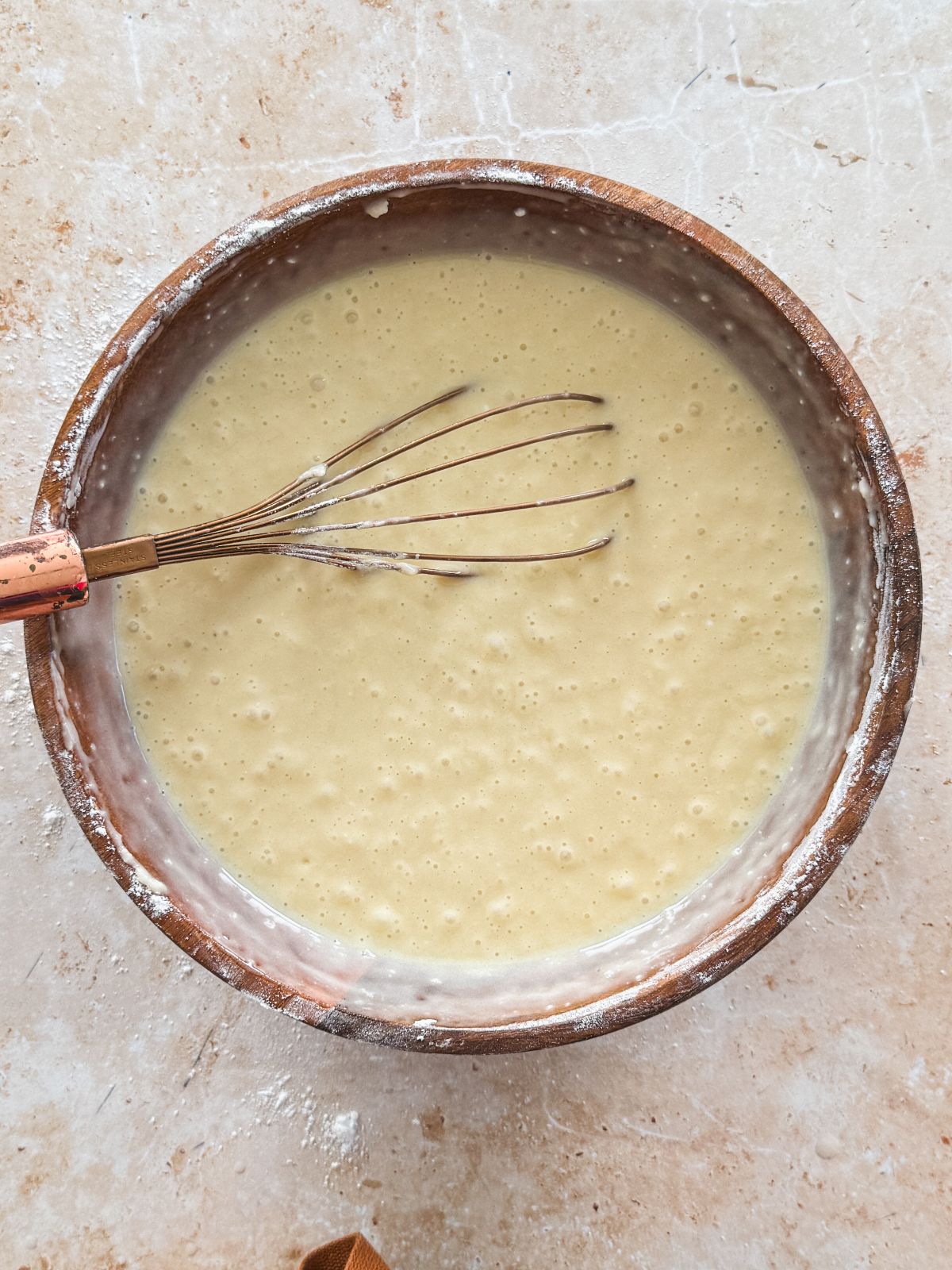 cake batter with dry ingredients mixed in in a wooden bowl