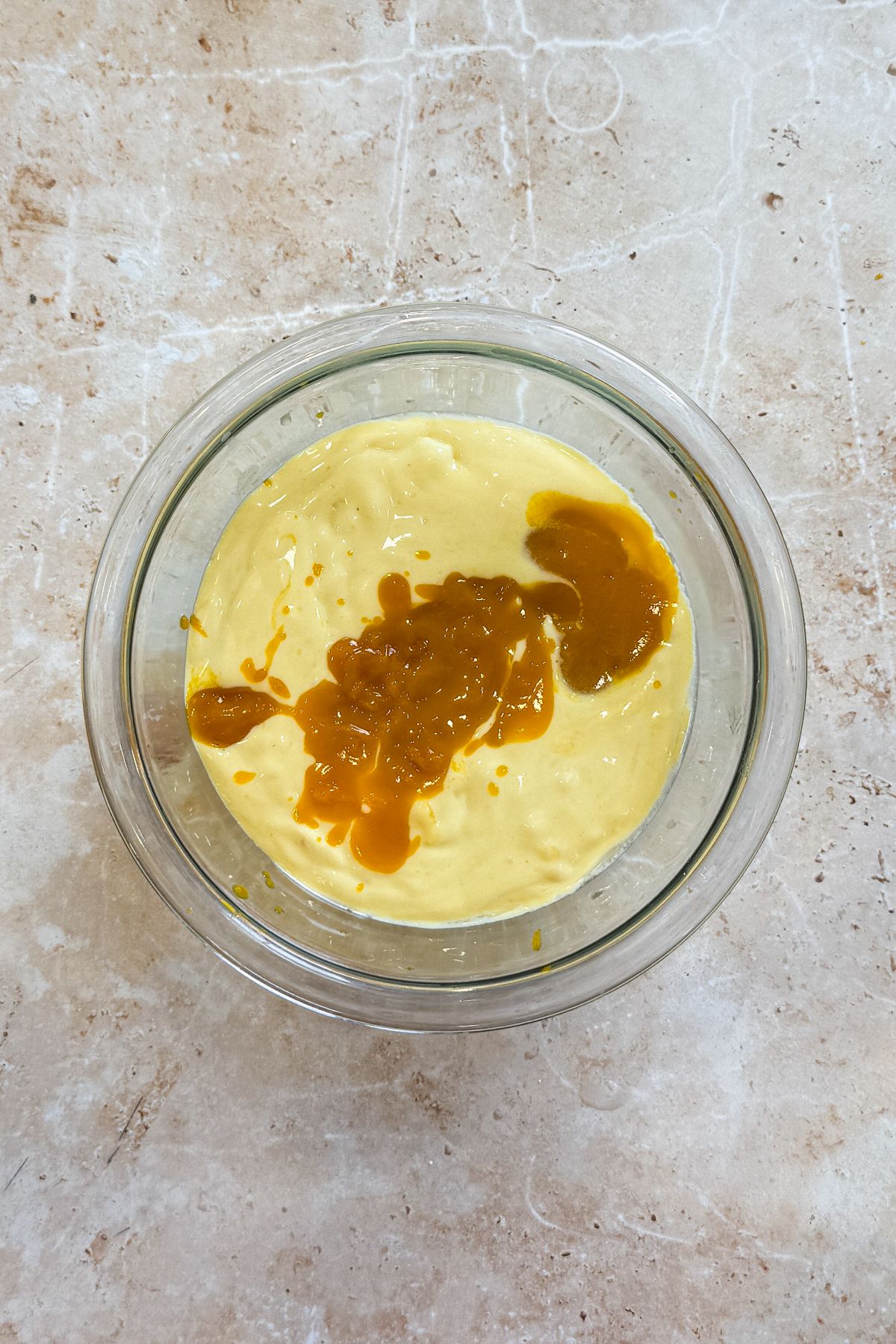 mango ice cream and mango pulp in a small glass bowl