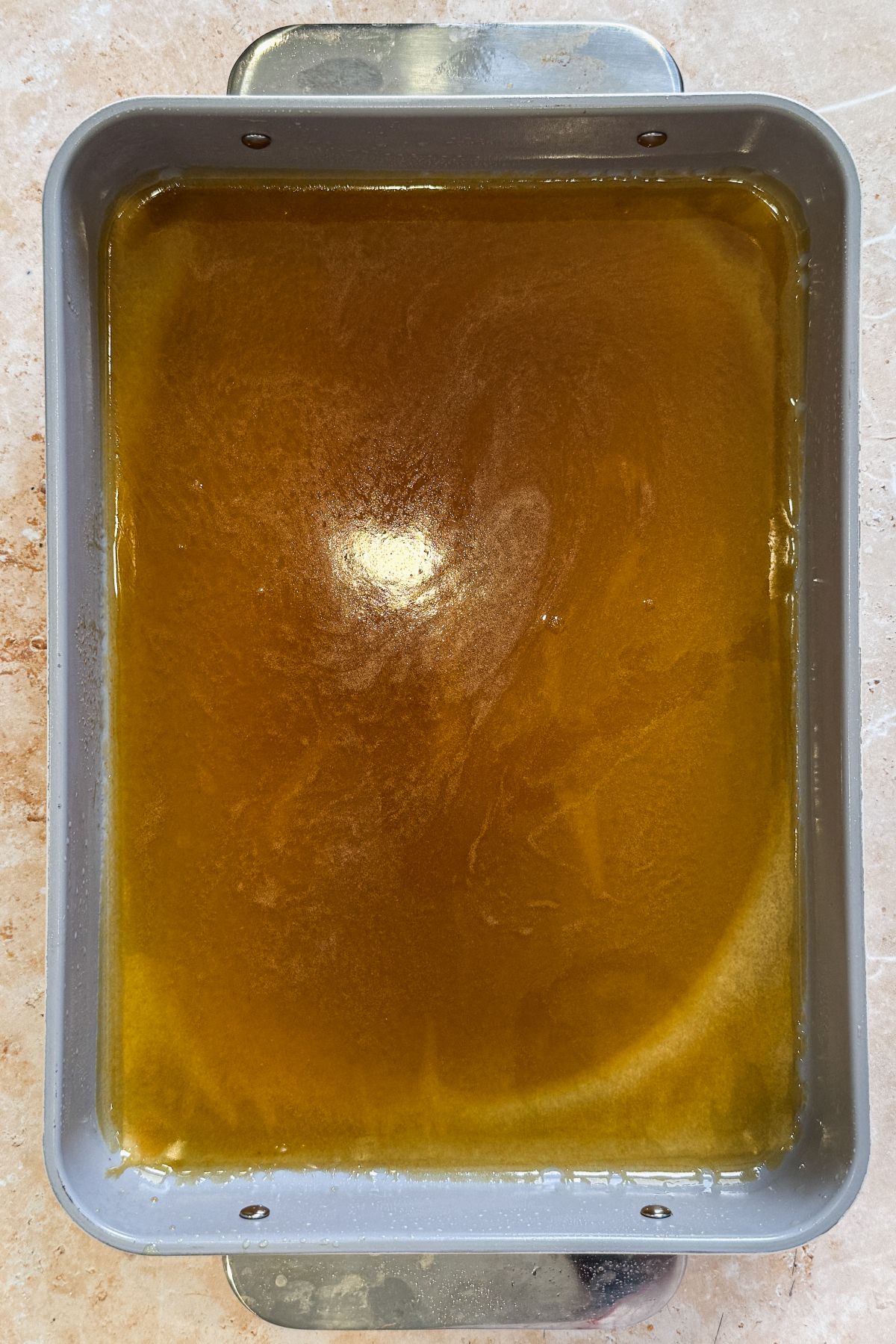 sticky maple sauce spread on the bottom of a rectangular pan