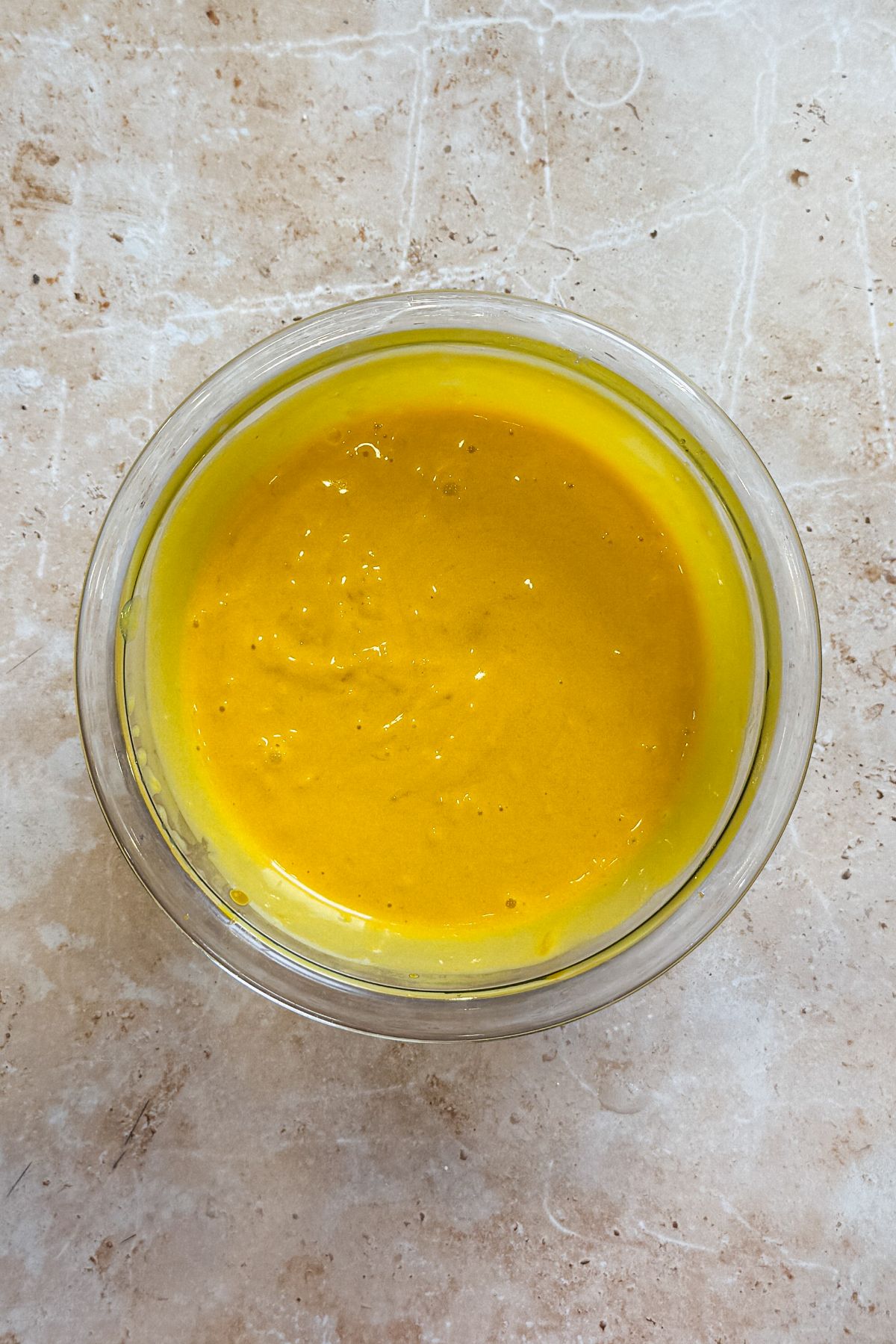 mango pulp, ice cream and gelatin mixed in a small glass bowl