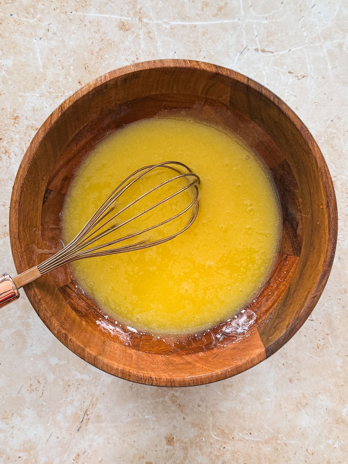 eggs, sugar and oil whisked until combined in a wooden bowl
