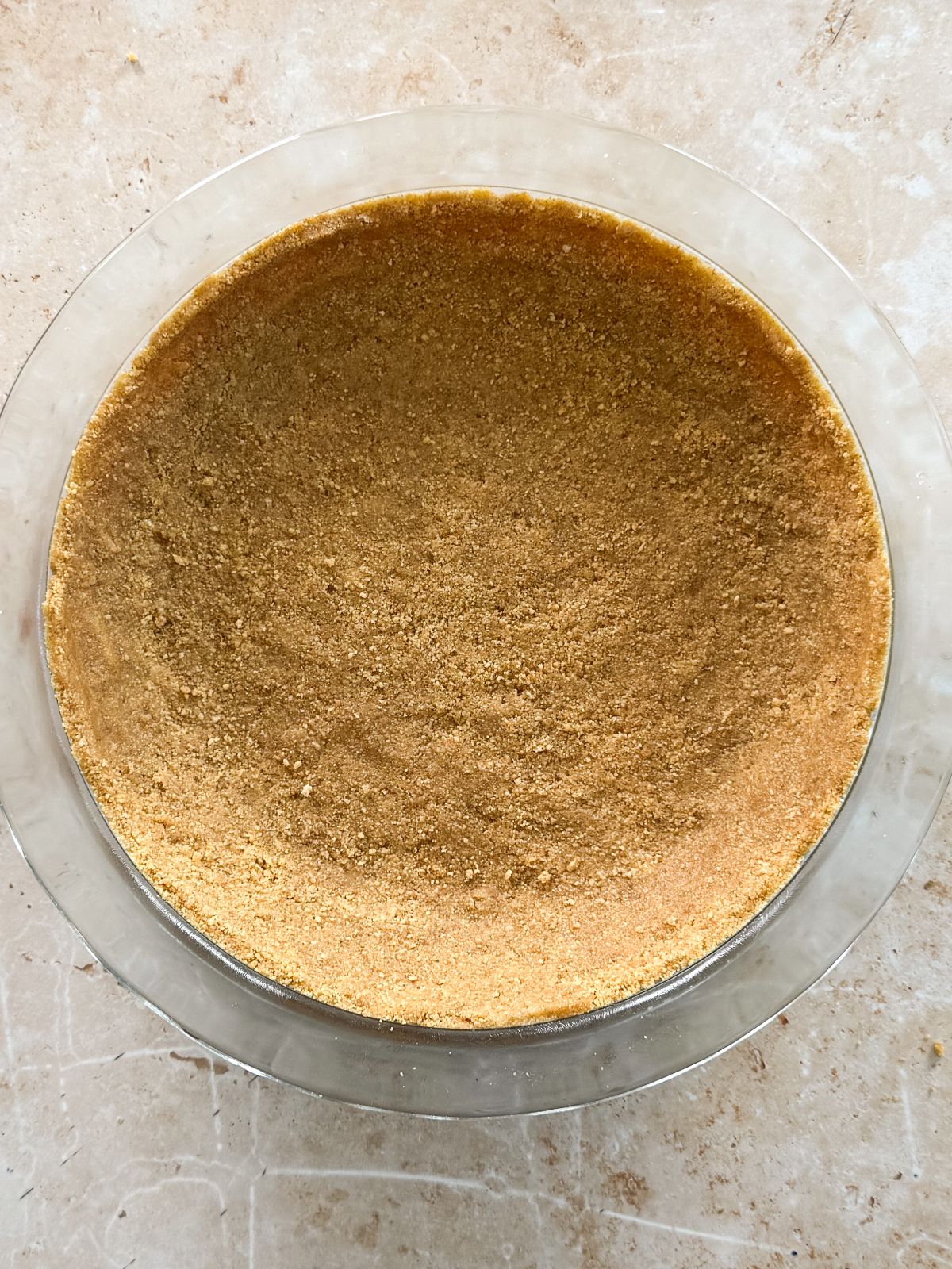 key lime pie crust baked until golden brown in a glass pan