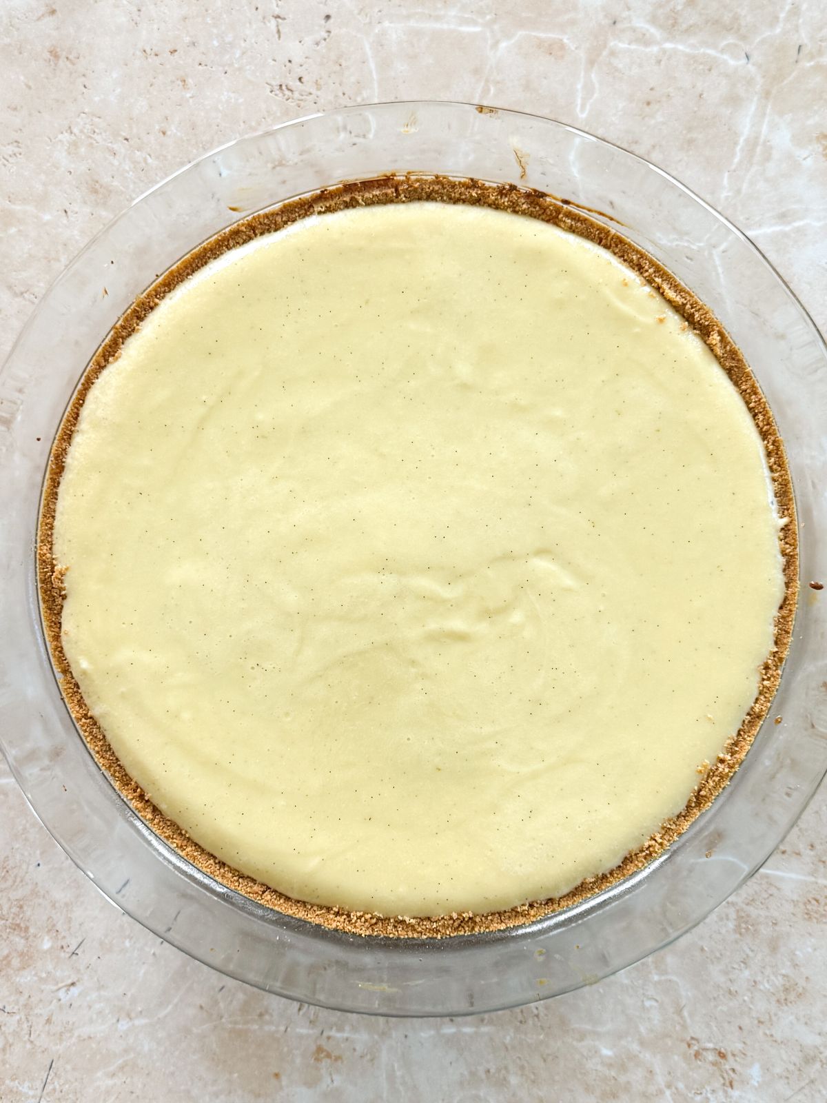 key lime pie in a glass pan baked until the edges are set