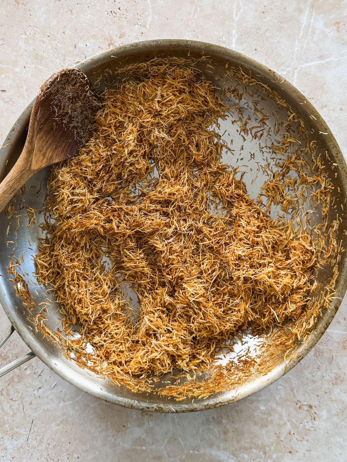 crispy, brown shredded kataifi in a stainless steel pan