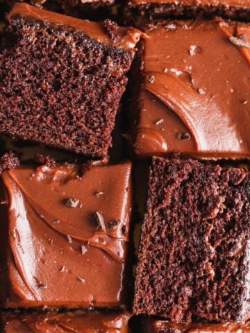 overhead picture of square slices of chocolate cake with 2 slices placed sideways; cake has a ganache frosting