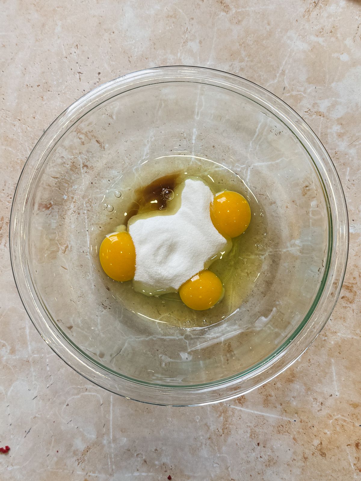 eggs, sugar and vanilla in a glass bowl