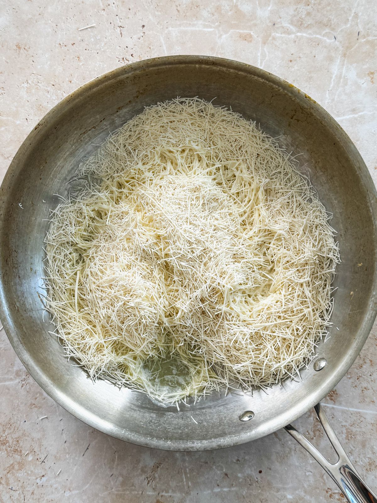 shredded kataifi and melted butter in a stainless steel pan